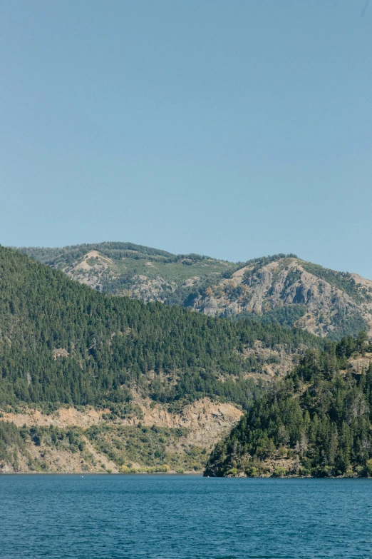 a very beautiful view of a green forested hill