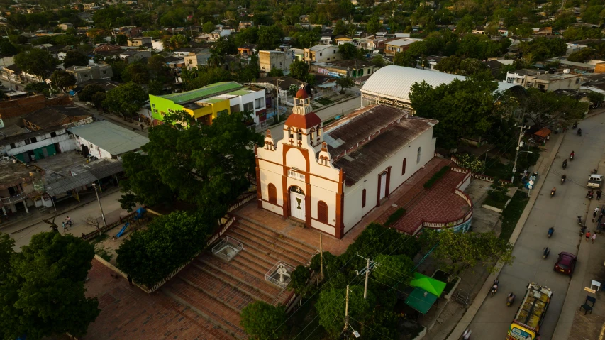 an aerial view of a church in a neighborhood