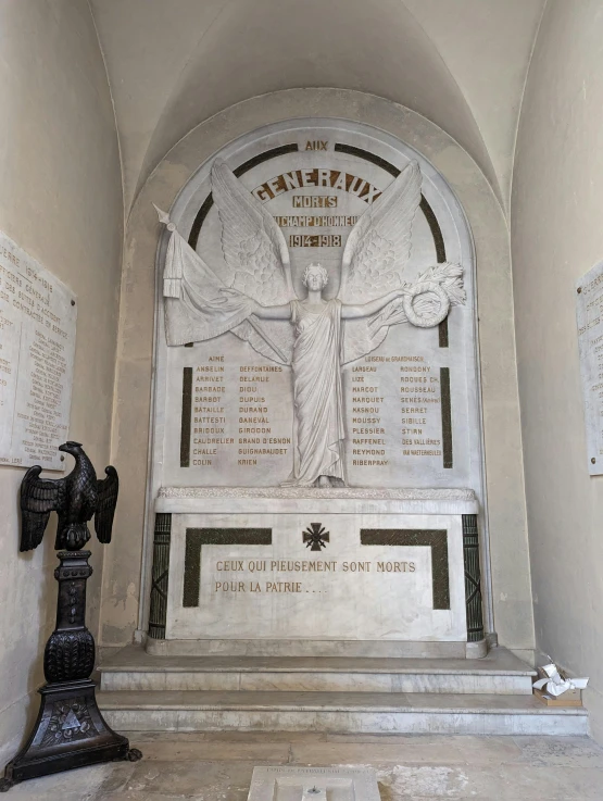 a large memorial has a cross at the bottom