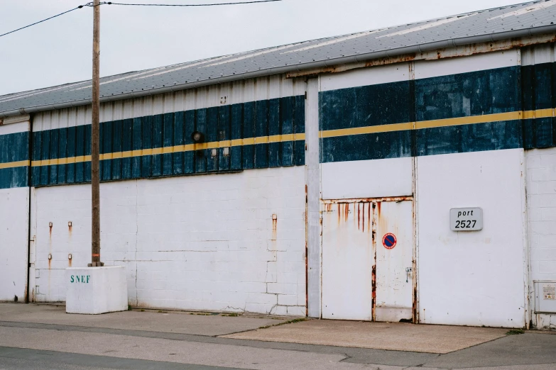 a white building on a side walk with a red stop sign