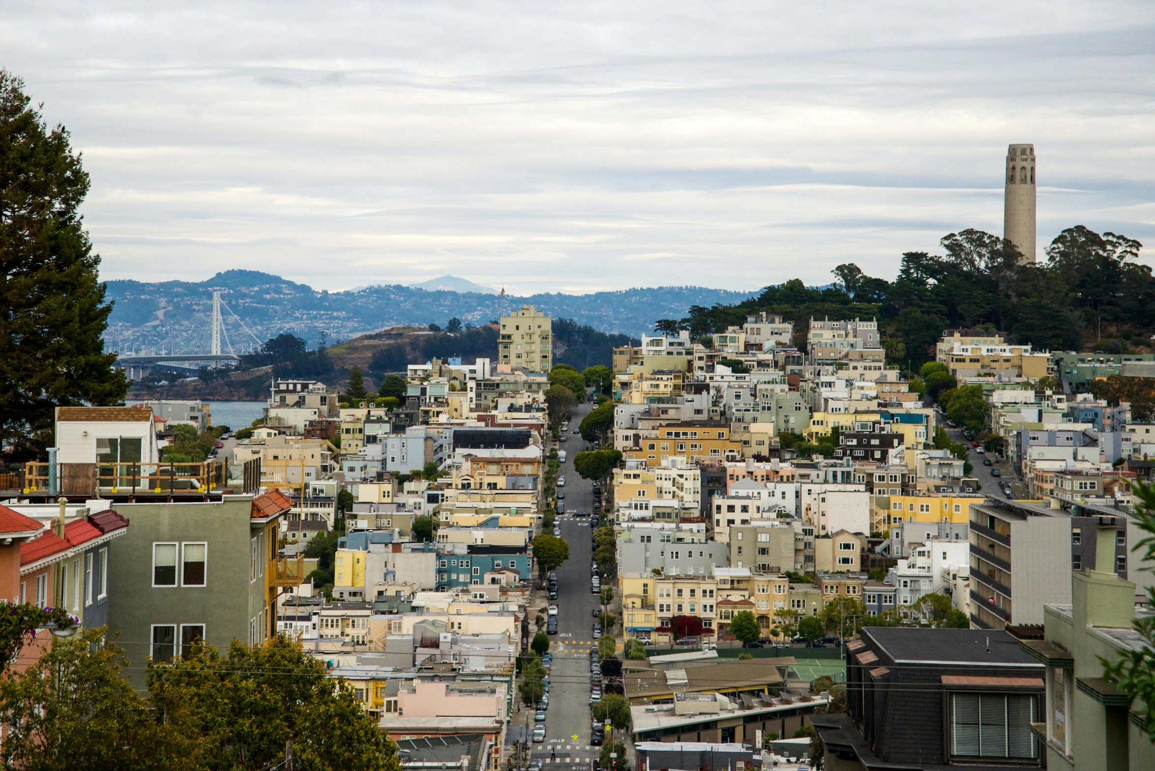 a hillside is filled with yellow and white homes