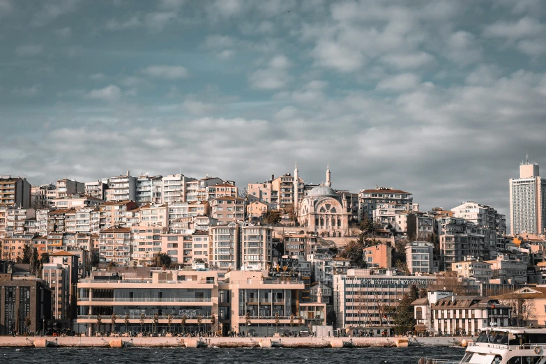 large buildings sit near a city next to a body of water