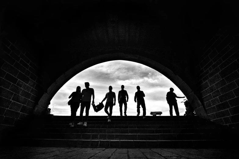 a group of men standing on top of a set of stairs