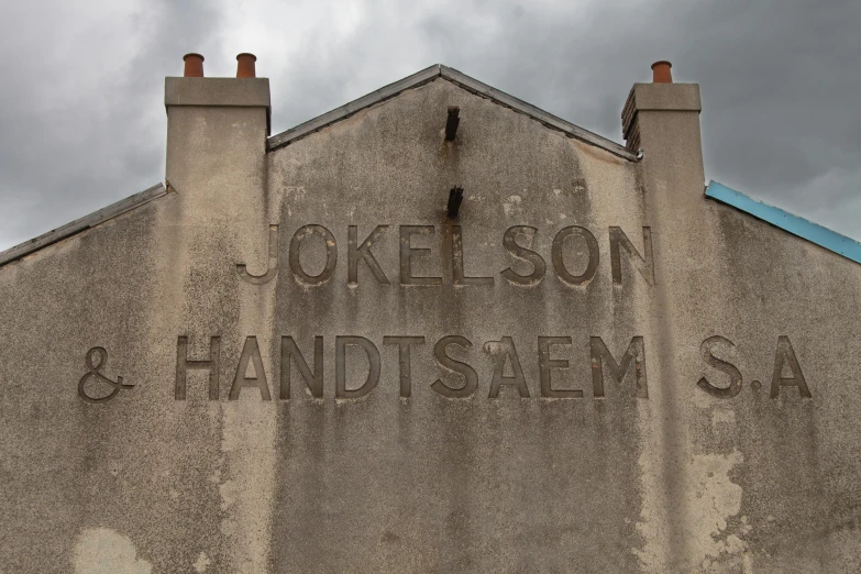 an old building with a carved word on the wall