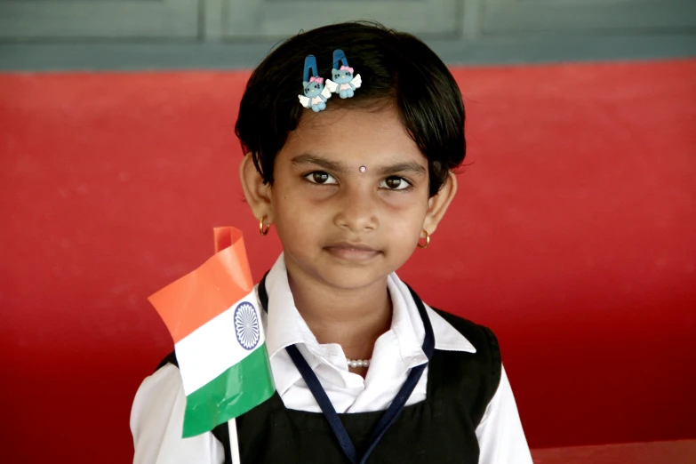 there is a girl that has an indian flag on her head