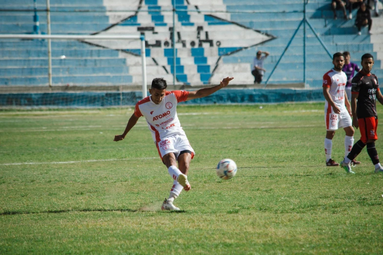 people are playing soccer in the field while one person is standing up