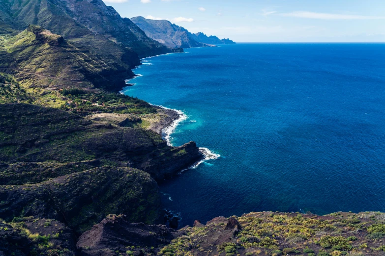 aerial po of the coast and hills near a body of water