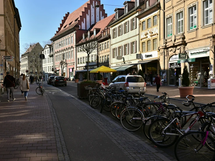 the street has several parked bicycles on both sides