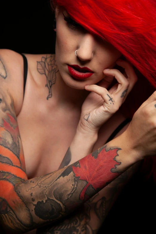the woman is covered with lots of tattoos