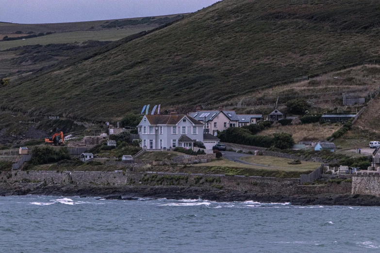 a house on a island with a long path running past it