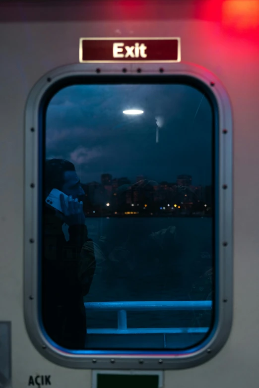the window on a subway train looks out at a waterway