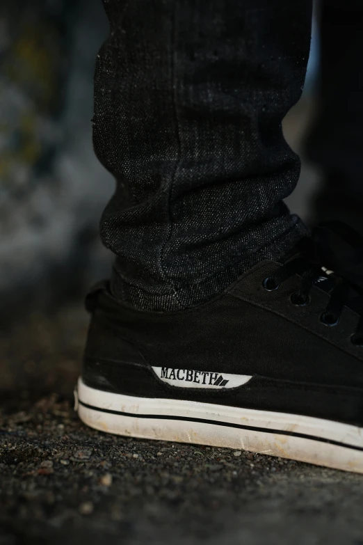 closeup of a black tennis shoe with white laces