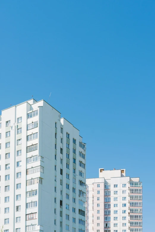 an airplane flies over some tall buildings