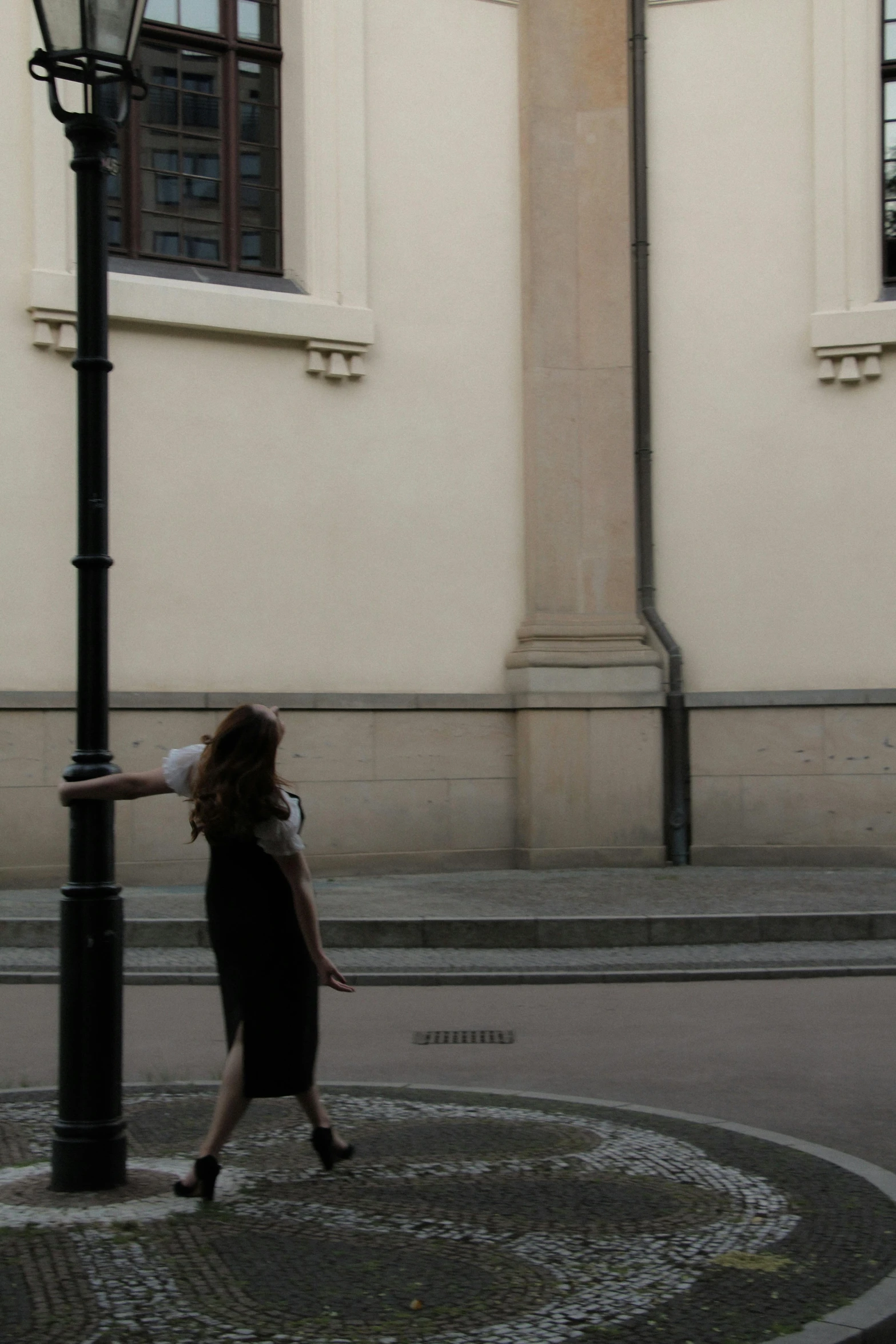 the woman is walking alone on the street