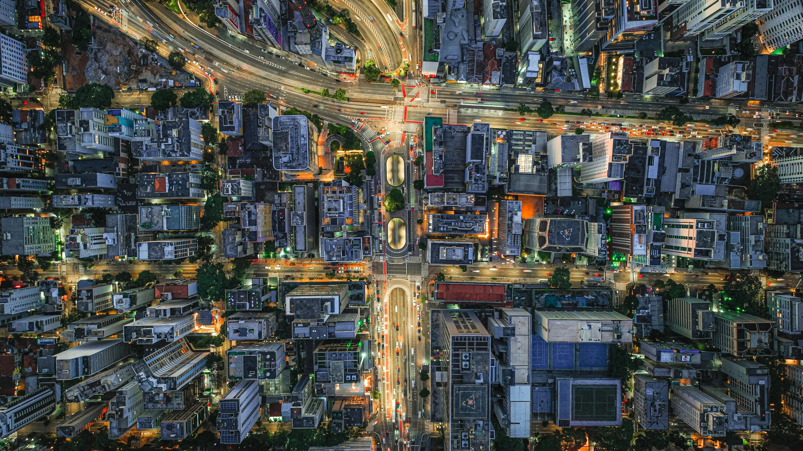 a busy city with tall buildings and an overhead view of traffic