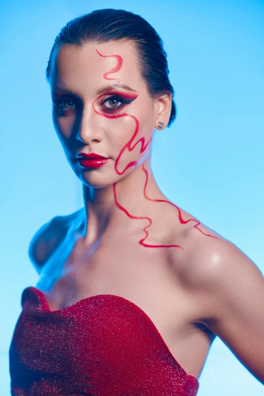 a woman in a red dress with her eyes painted red