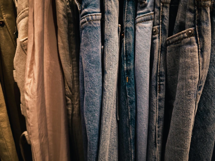 there are a lot of jeans on the shelf