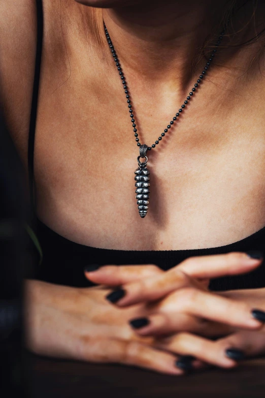 an image of a womans neck with her hands resting