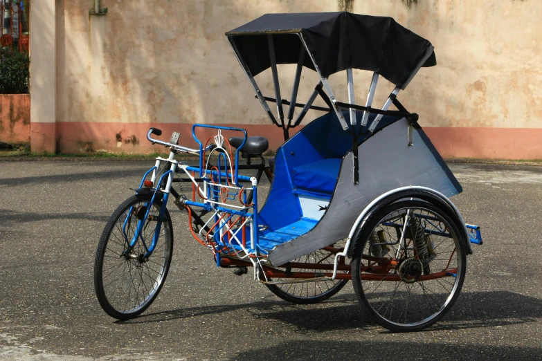 a bicycle with a trailer that has a roof