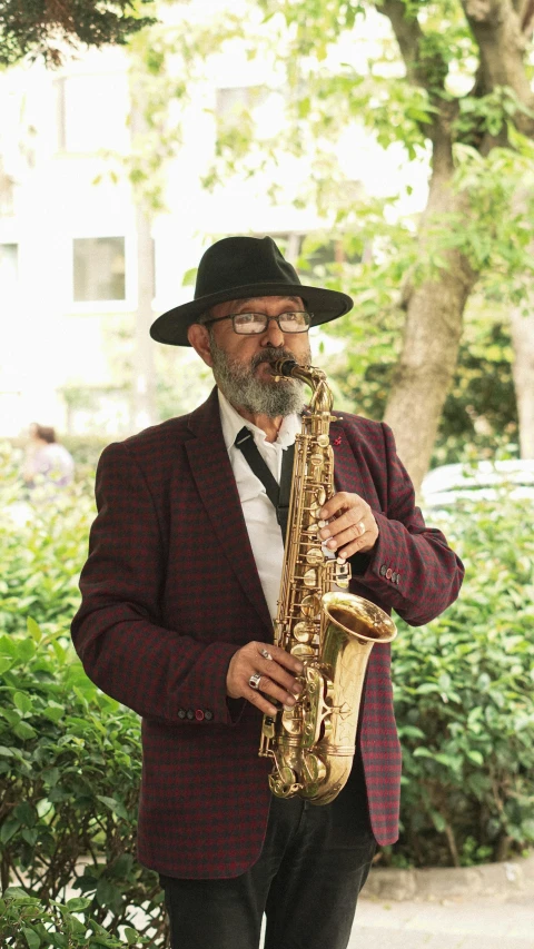 a man that is holding a saxophone in his hands