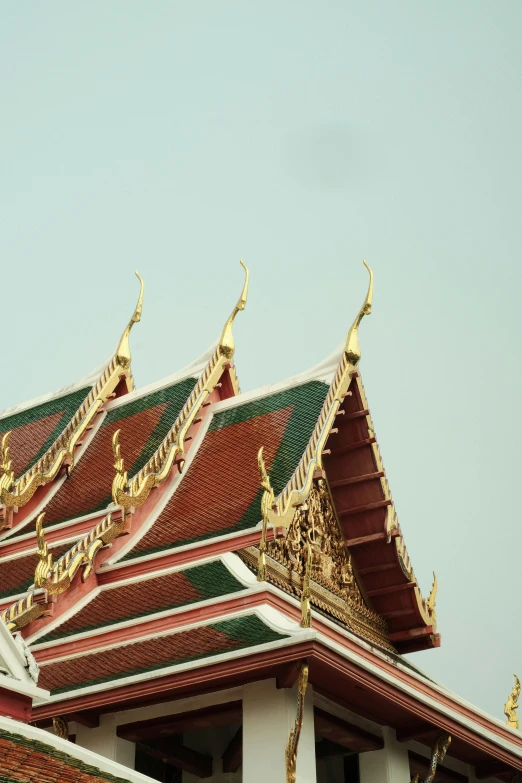 this building has multiple ornate roof designs on it