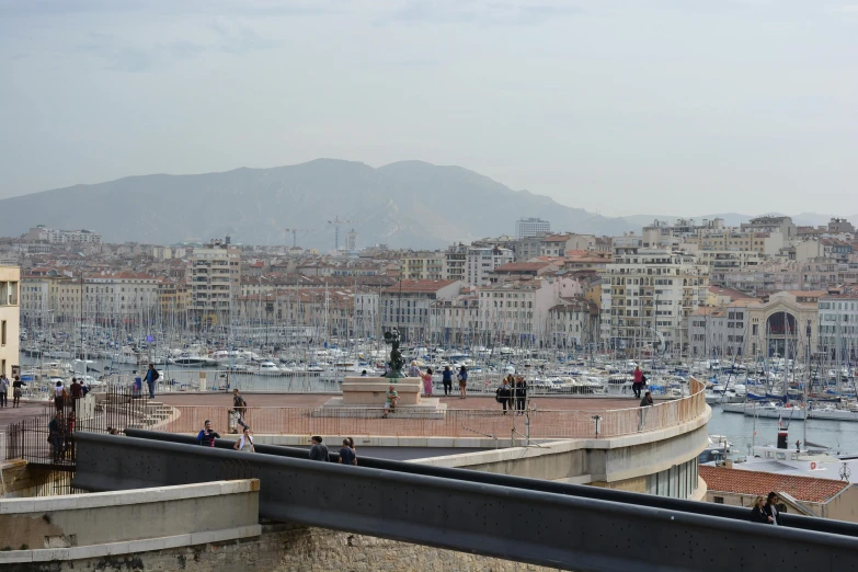 some people are walking on the water near many buildings