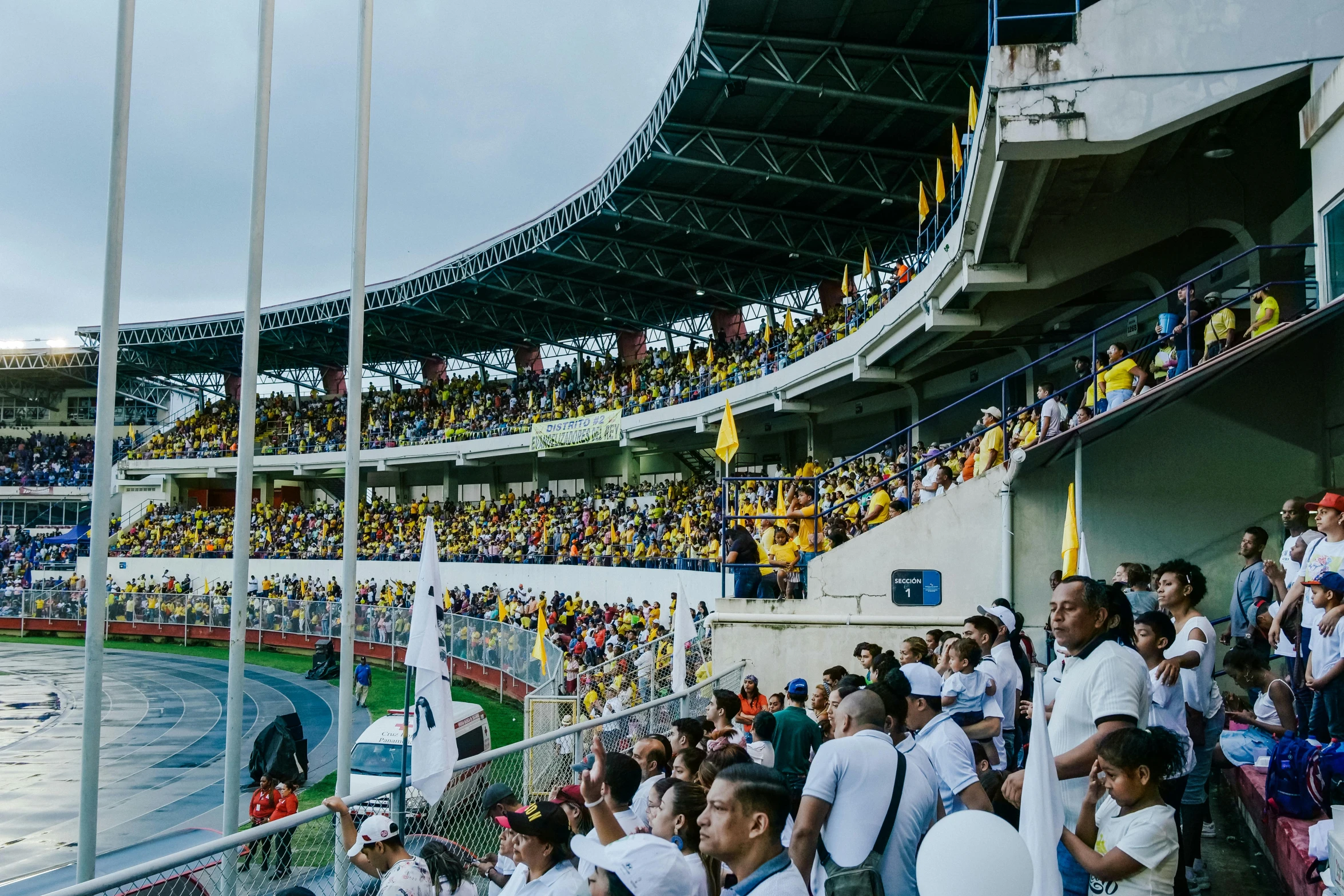 a large crowd of people are watching a football game