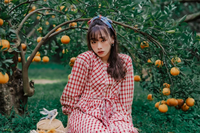 girl sitting in an orchard with fruit