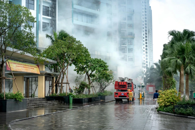 people and a fire truck on a wet city street