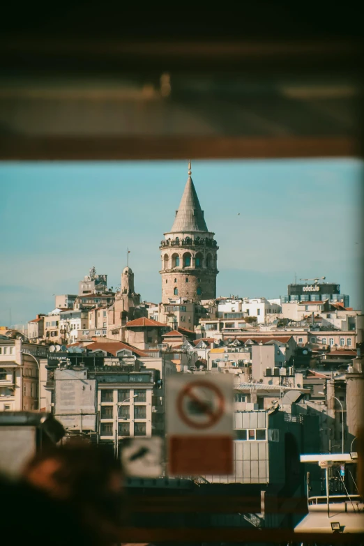 a tower with a spire sits atop the city