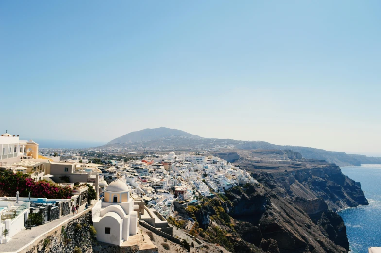 some white buildings and a very pretty mountain