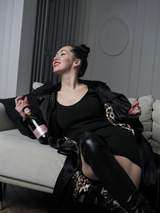 a beautiful woman holding a bottle of wine