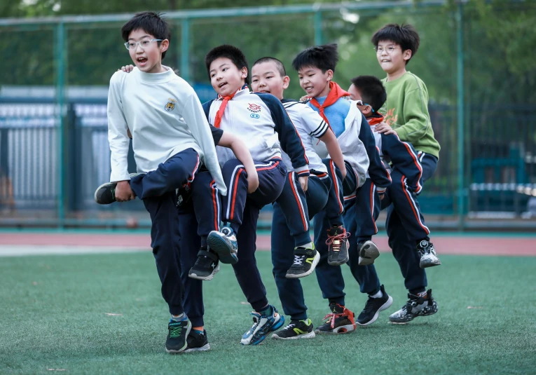 a group of young children on a soccer field