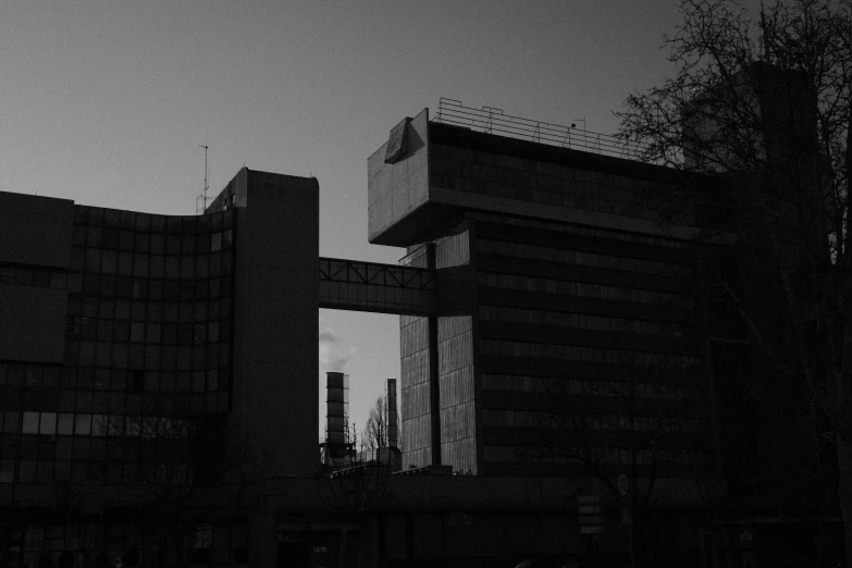 buildings in a city with dark shadows and a clock tower