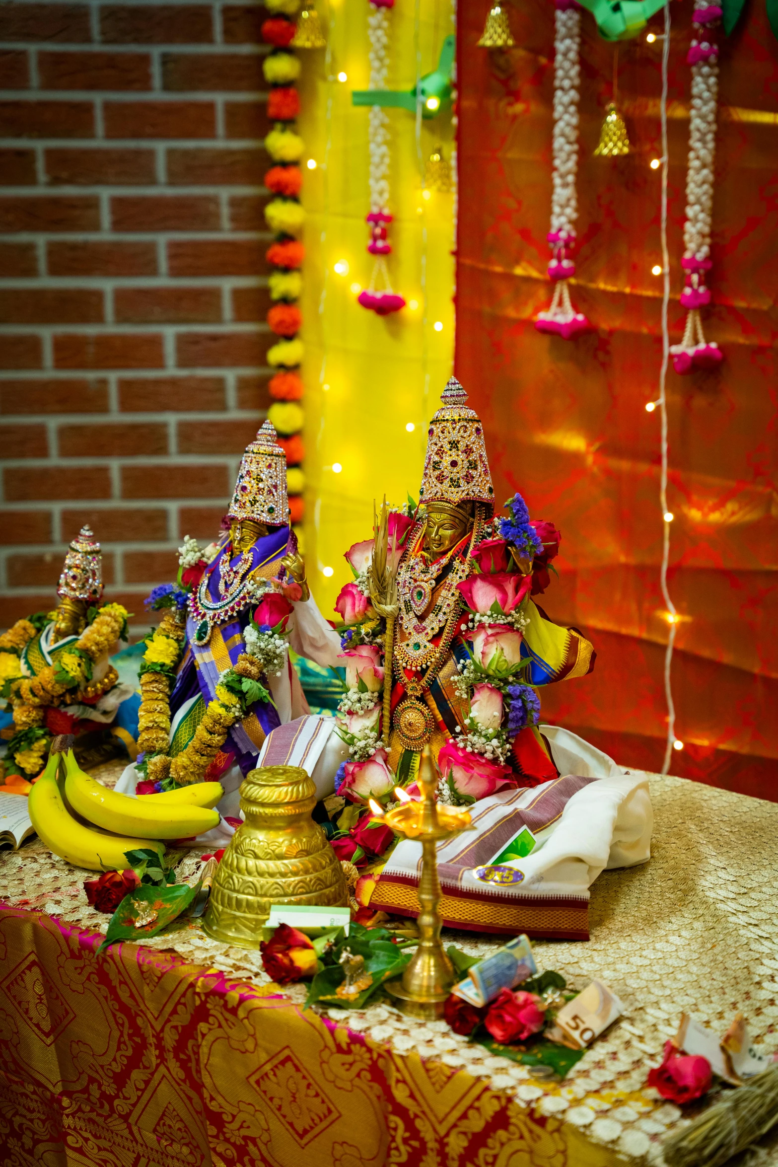 several small statues on top of a table near a wall