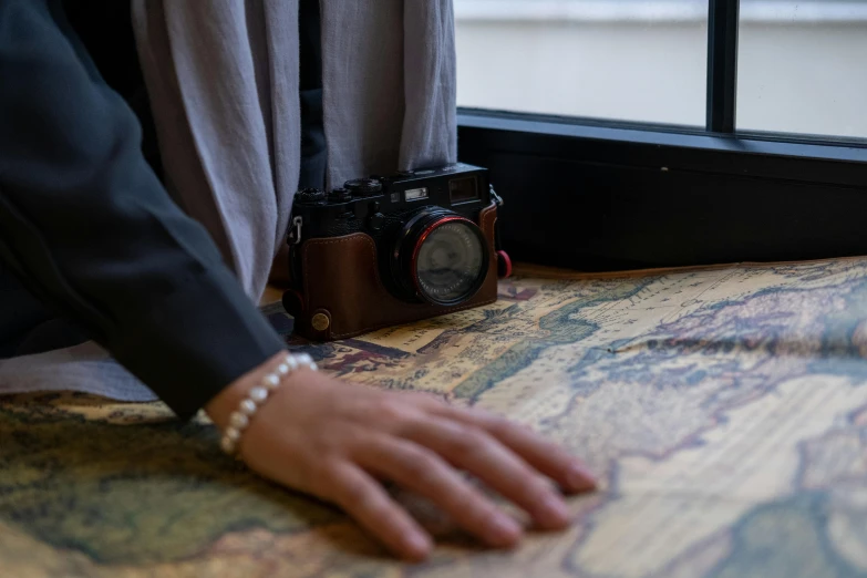 a person with their hand resting on a map