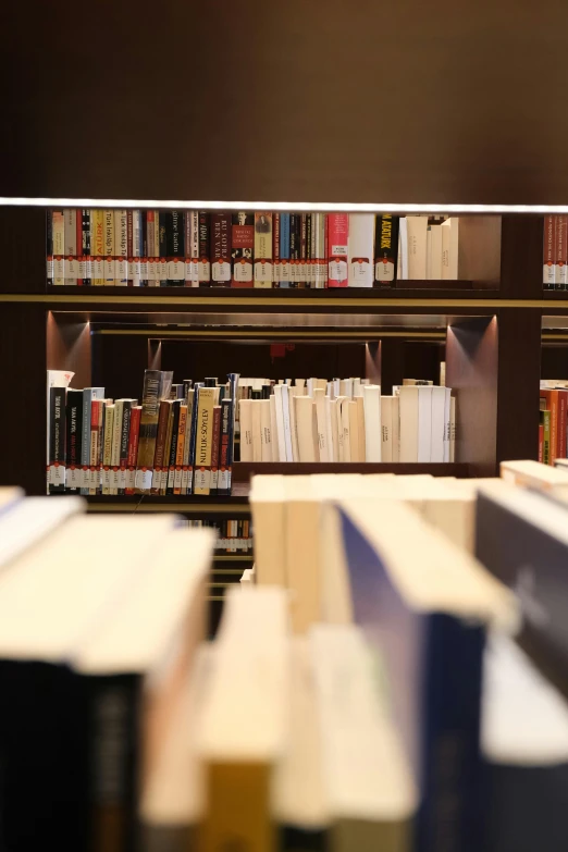 several books are stacked on a shelf in a bookstore