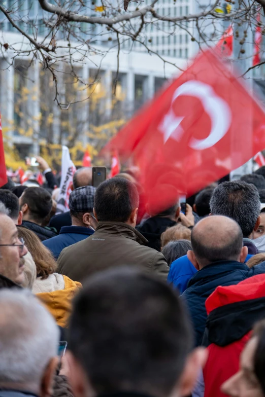 the people are protesting with flags on the street