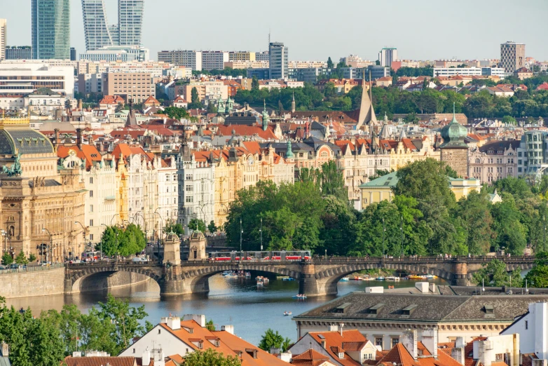 a train is passing over a bridge in a city