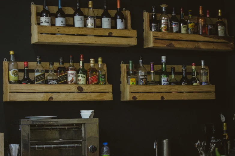 several shelves have empty bottles on them