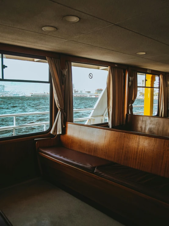 the sailboat floats along the water by the window