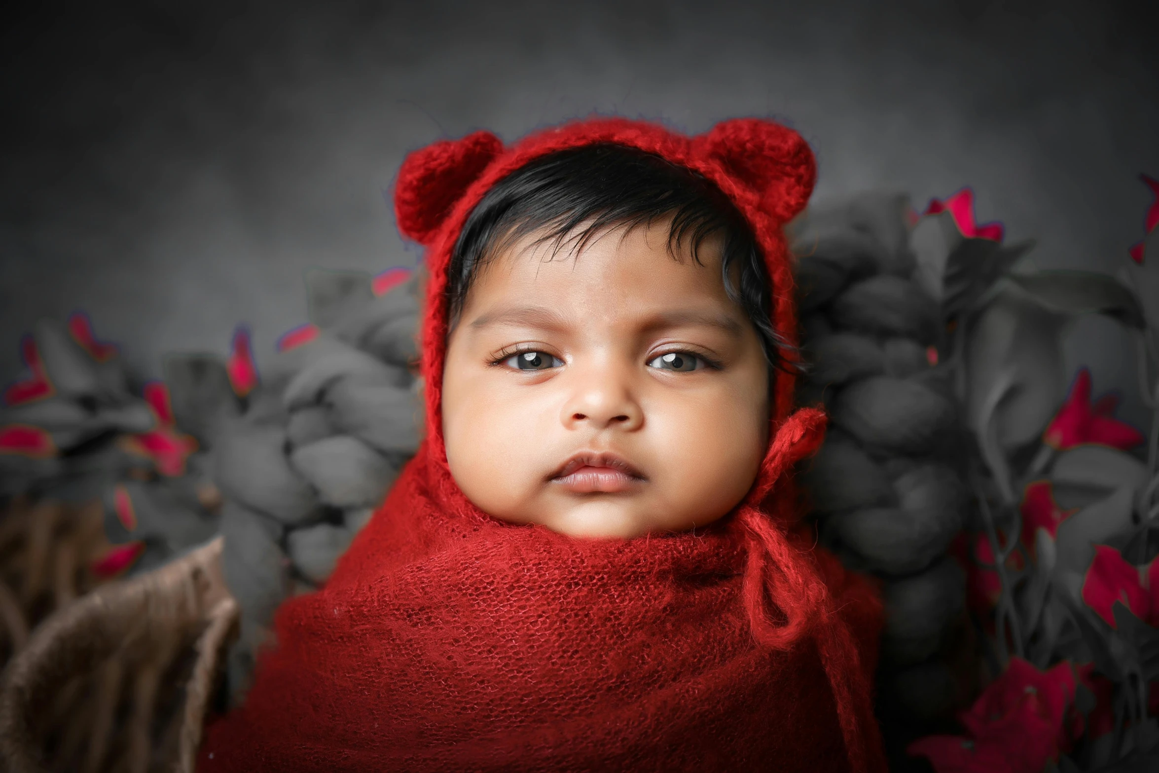 a young child wearing a red bear outfit