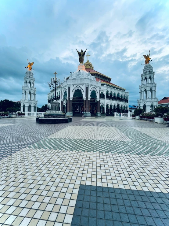 a large building has statues of angels at top of it