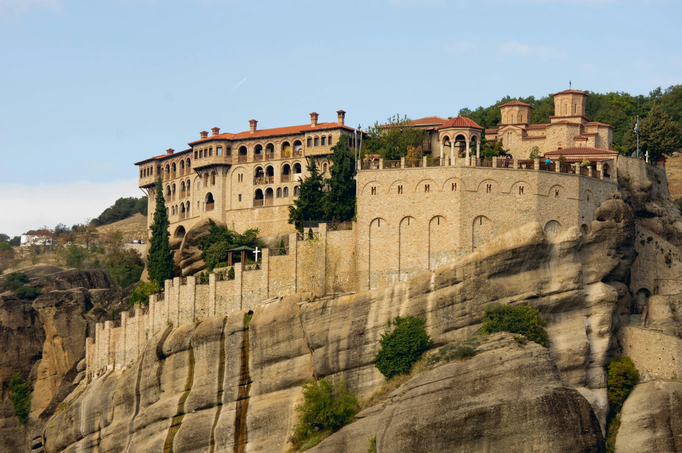 the large castle is perched on top of the mountain