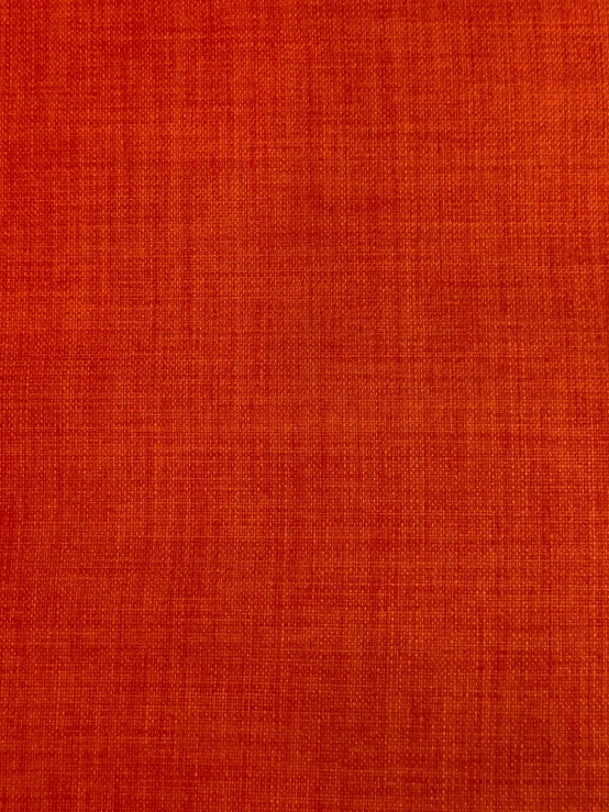 a close up view of red cloth with a little light on it