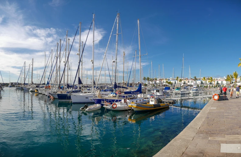 several boats in the harbor with blue water