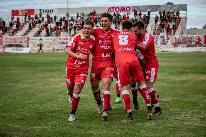 a soccer team celeting a goal in the middle of a game