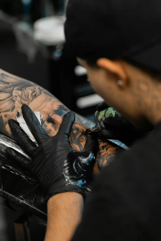 someone getting their tattoos done in a salon