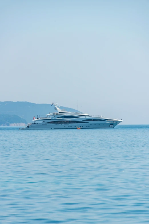 a boat floating in the ocean next to a large boat