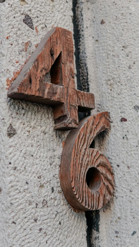 a closeup of a decorative letter that appears to be made from wood